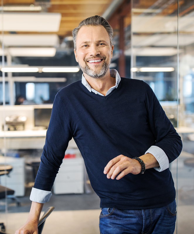 Mature, smiling man in office