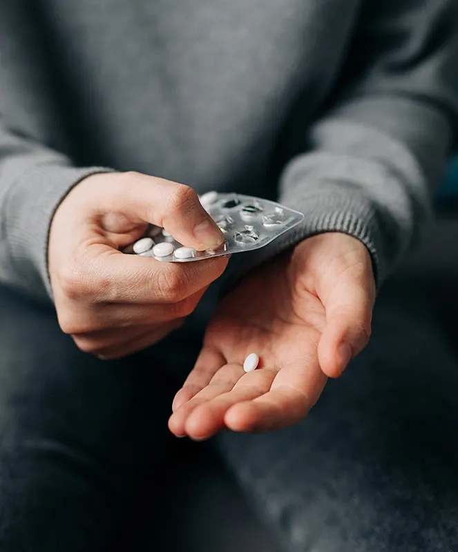 Patient holding pills in hands
